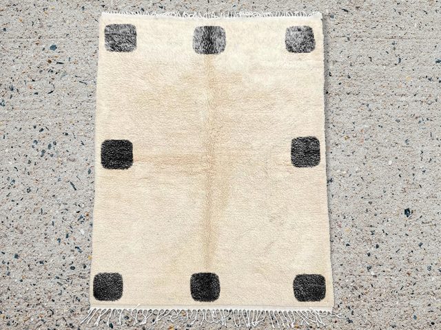 Moroccan Beniourain rug hand knotted with black squares on the edges